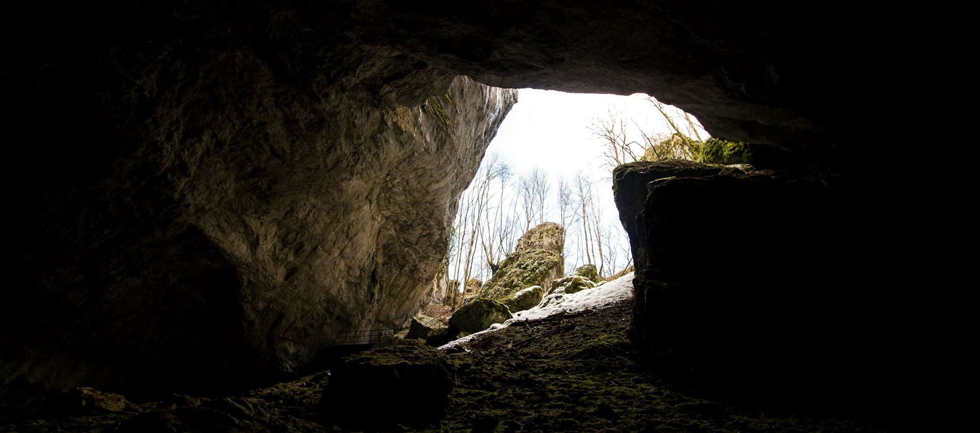 a dark cave with a light at the end