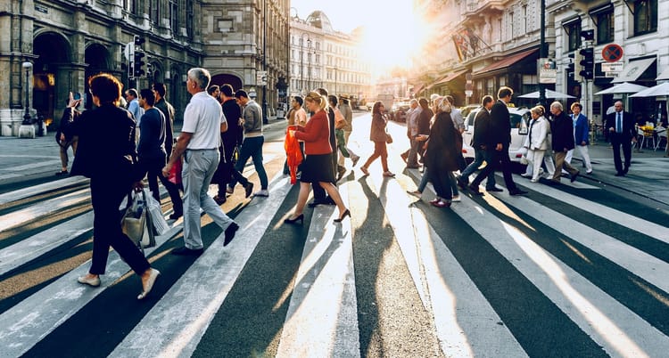 Photo image of people crossing a road.